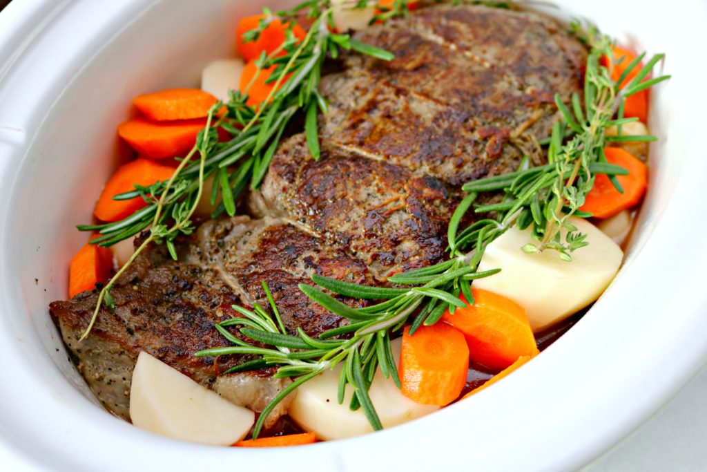 Top view of potatoes, carrots, and seared beef.