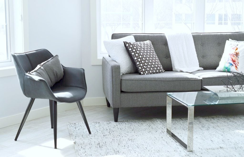 A living room with gorgeous grey and black furniture is shown.