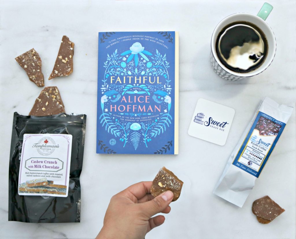A flat lay with all the contents of a Sweet Reads box. Milk chocolate, a book, coffee, and more.