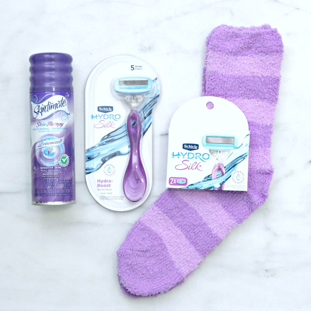 Skintimate Skin Therapy and Schick Hydro Silk with a set of purple socks and razor replacements. 