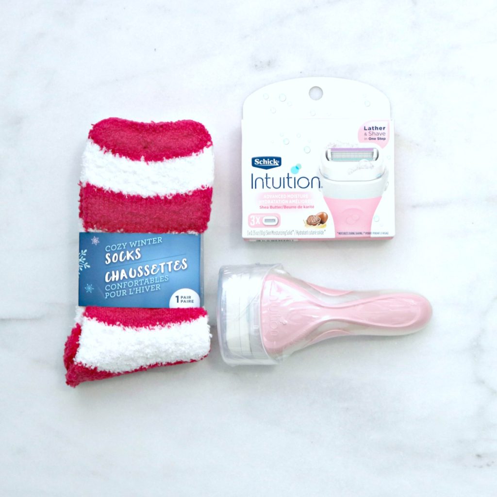 A pair of socks, a pink Schick Intuition and replacements. 