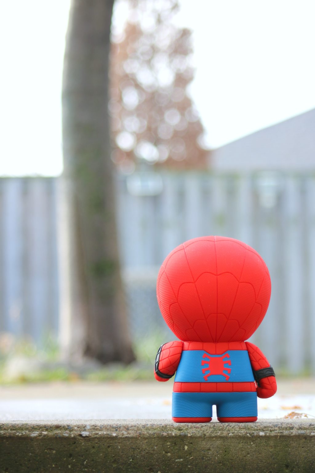 One of the Must-Have Gifts for Spider-Man and Marvel Fans! LIttle Spiderman stands outside in what seems like a big world, a tree is in front of him.