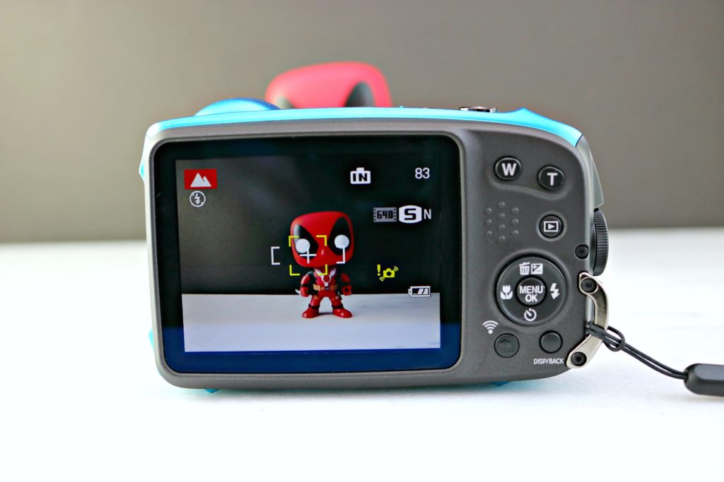 The viewfinder of the camera focuses on Deadpool action figure. 