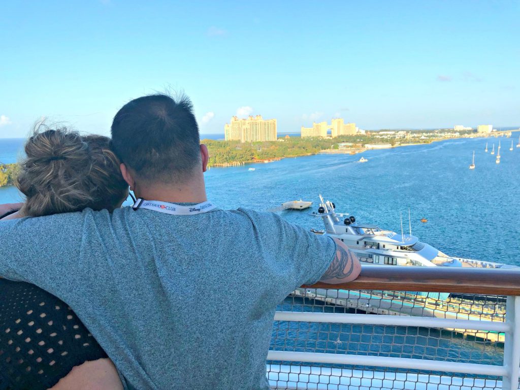 A couple hold each other while overlooking the port of Nassau. 