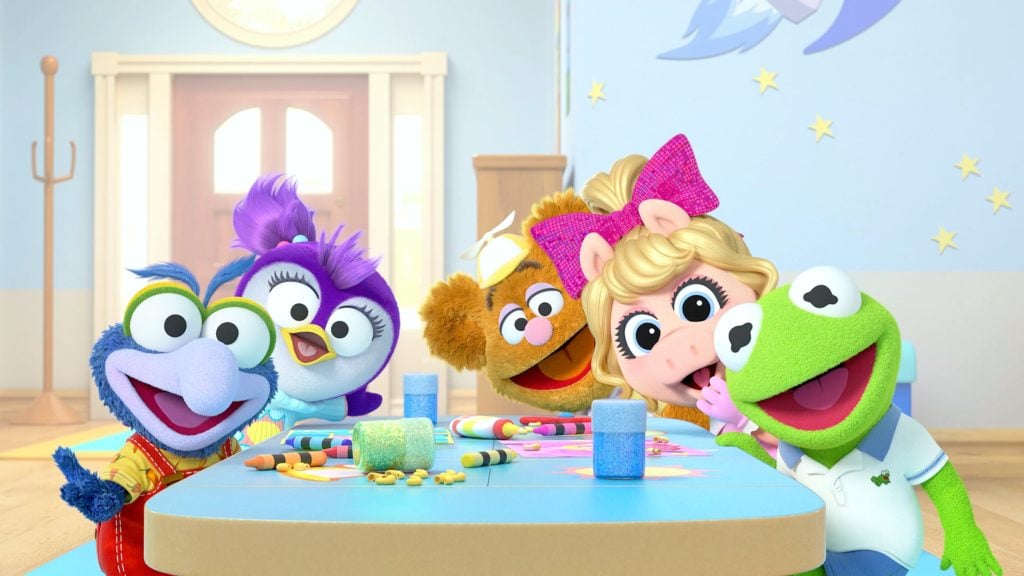 The characters of the NEW Muppet Babies sit around a table.