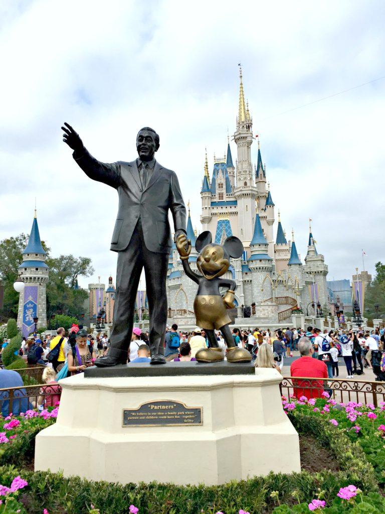 Walt Disney and Mickey Mouse statue in front of Cinderella's castle.