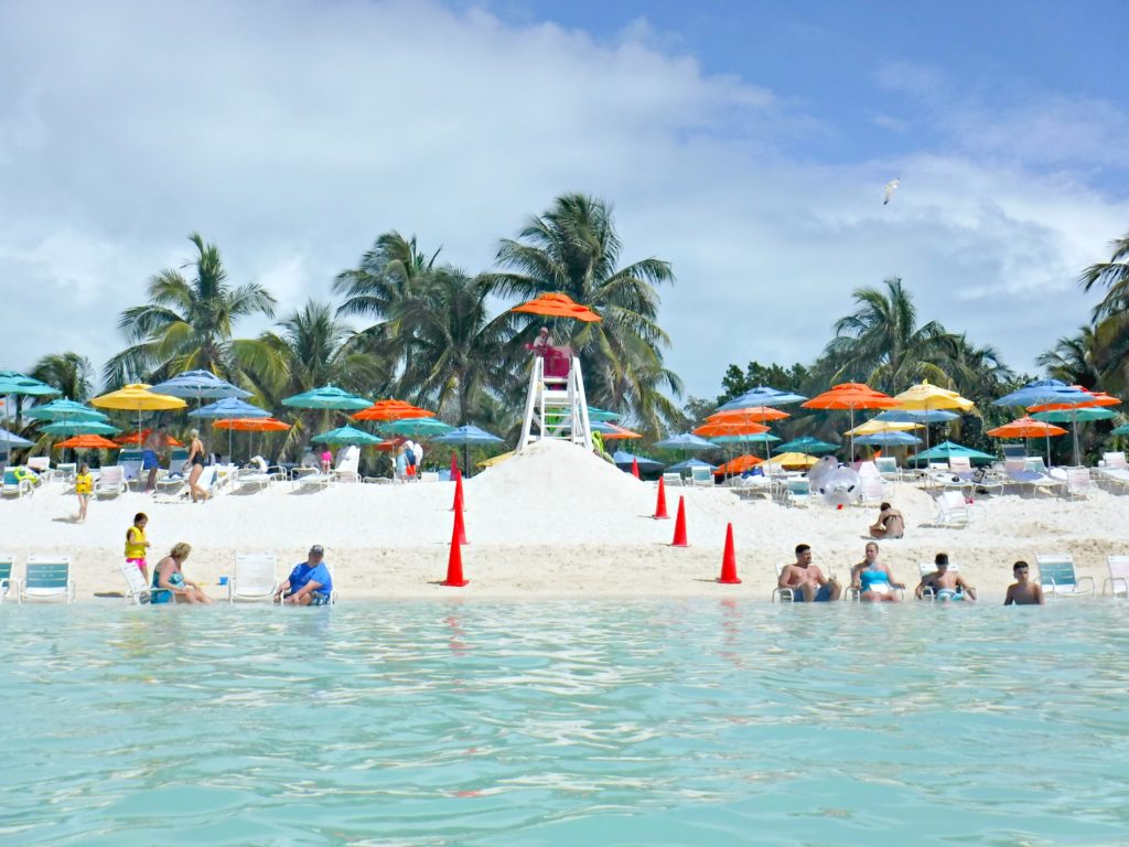 People relaxing on the family beach at Castaway Cay.