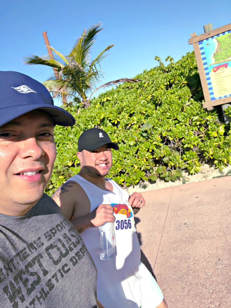 Two men take a selfie while walking the 5K at Disney's Castaway Cay. 