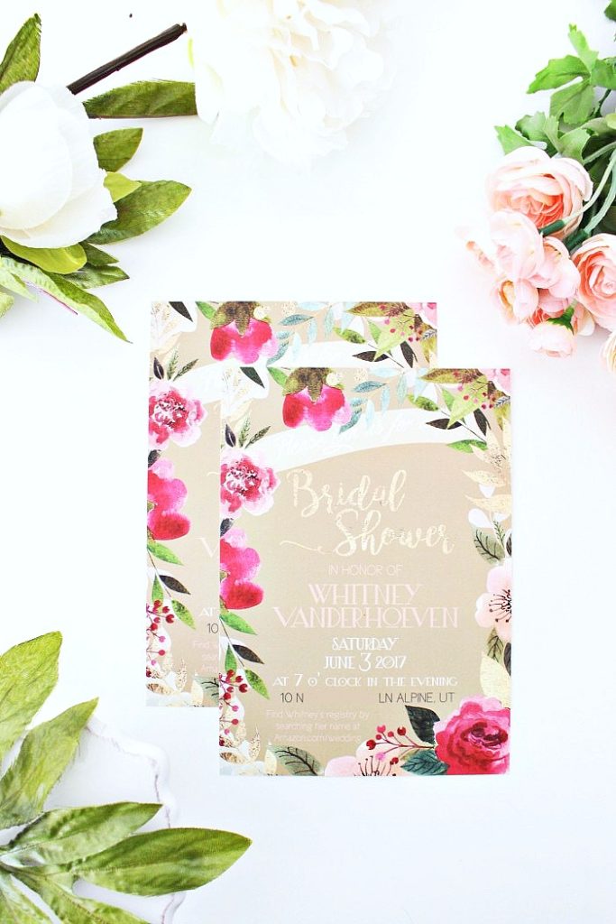 A bridal shower invitation is surrounded by flowers. 