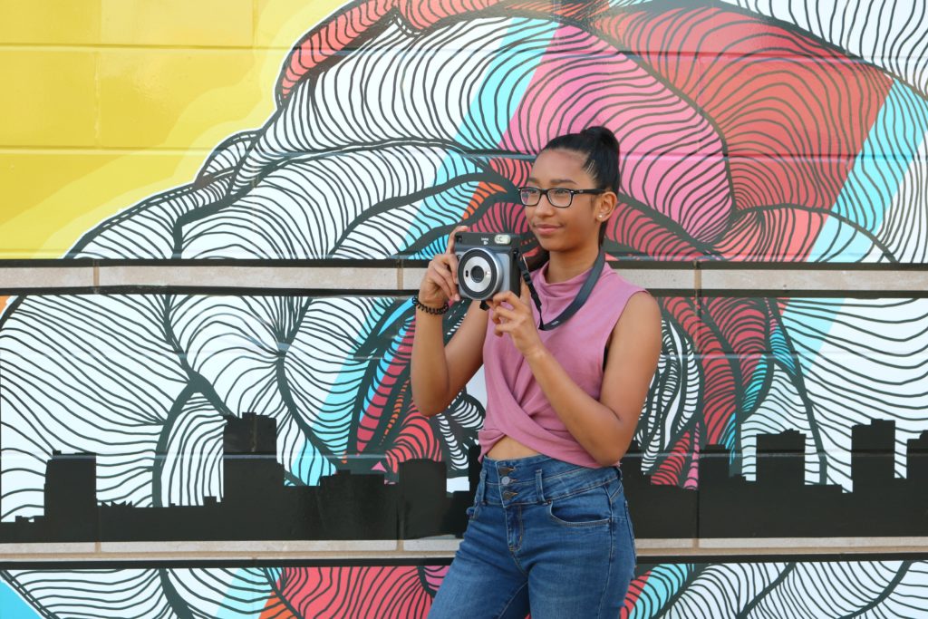 A girl looking to the distance to capture her next shot.