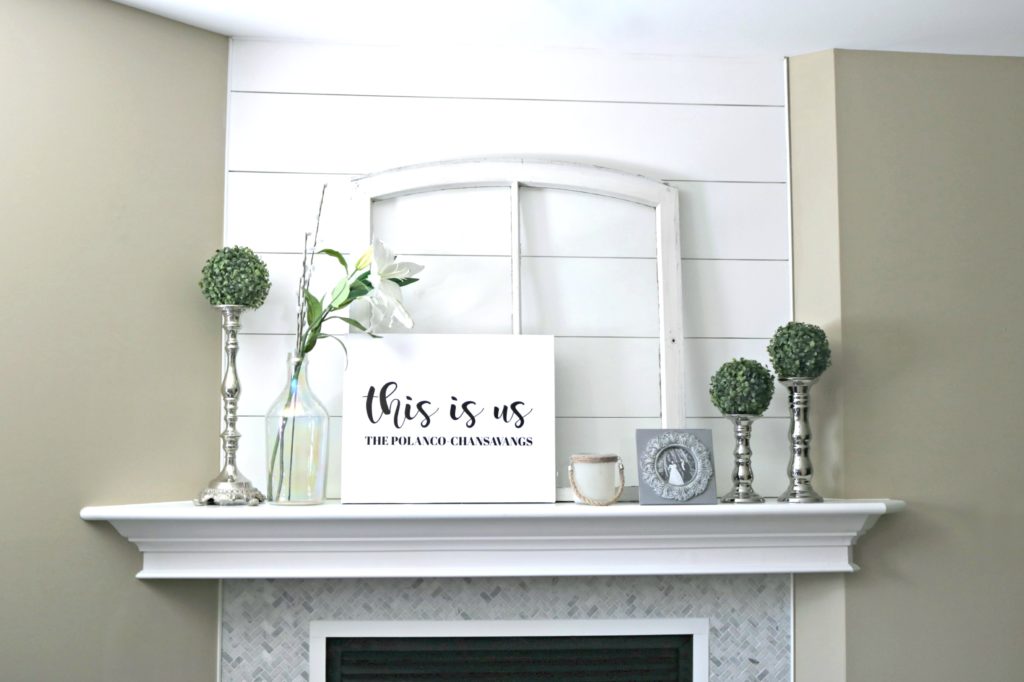 A mantle decorated with farmhouse rustic decor. 