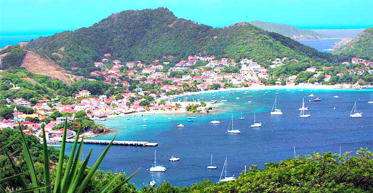 The beautiful bay of Guadeloupe is lined with sail boats. 