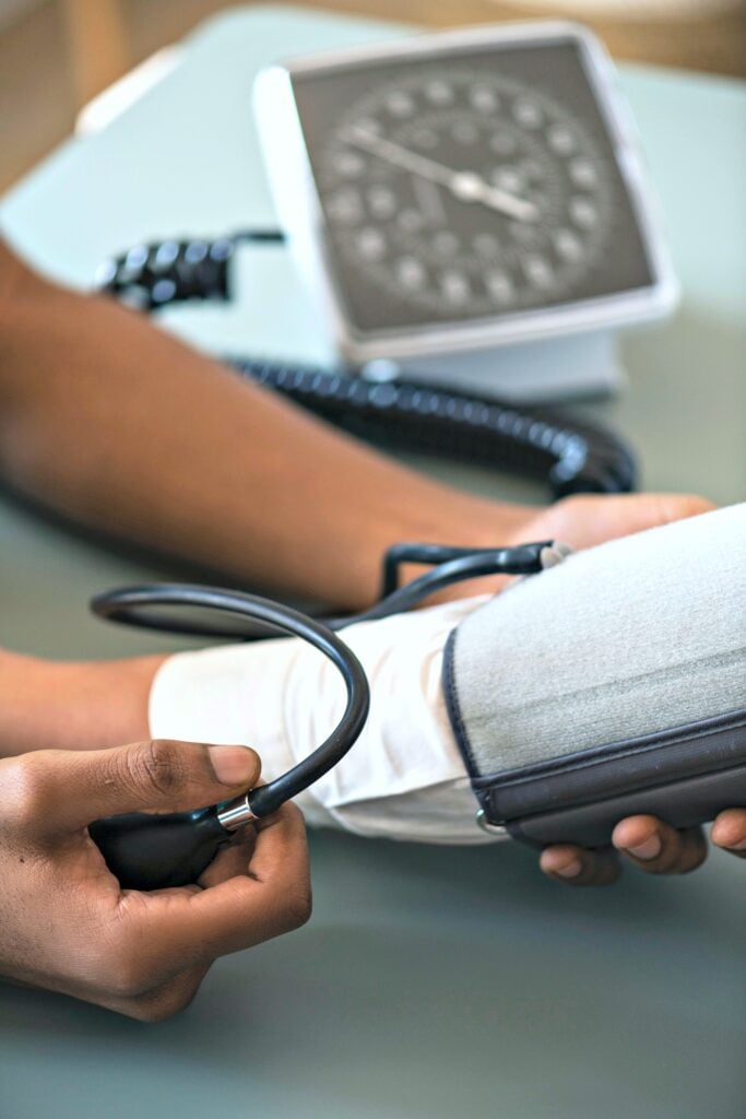 A nurse takes a patient's blood pressure. 