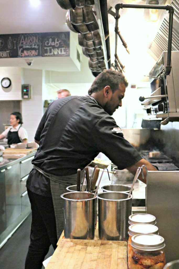 Chef Inni prepares appetizers in his kitchen.