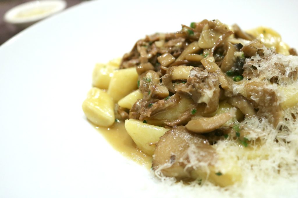 Handmade ricotta gnocchi, topped with mushrooms, beef, and Parmesan.