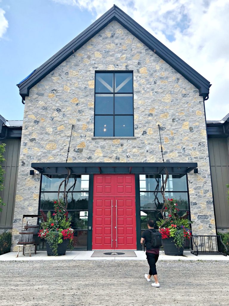 A man walks towards the Adamo Estate Winery. 