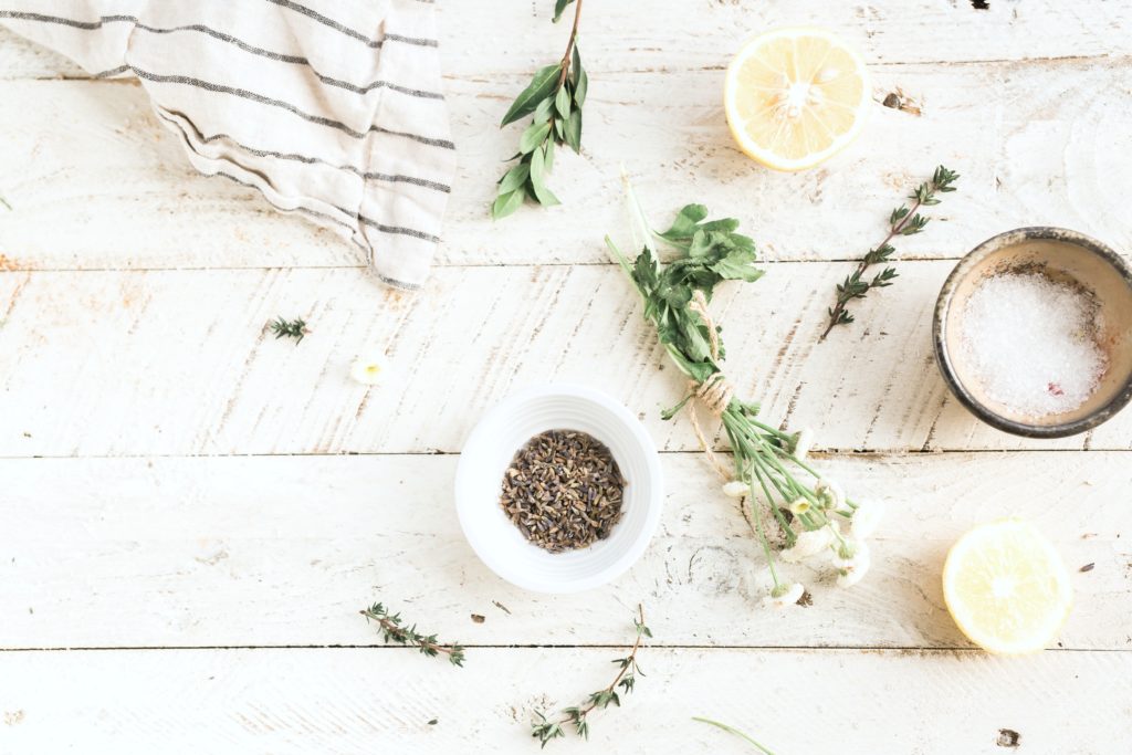 A little bowl filled with rosemary, salts, and lemon are displayed. 