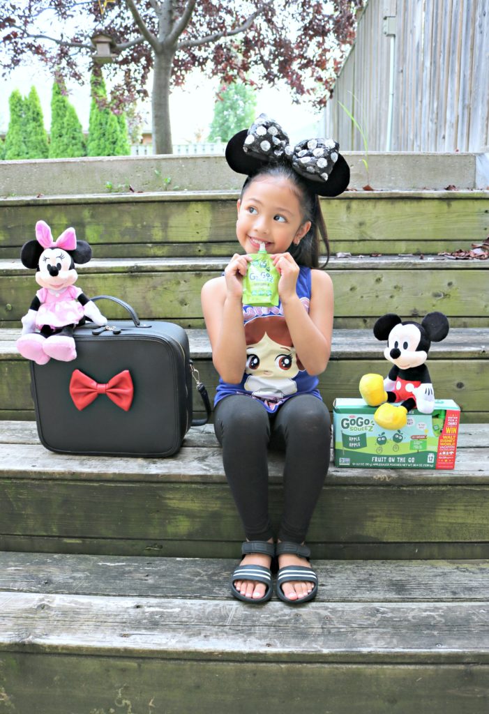 A little girl enjoys a Go Go SqueeZ and is excited at the possibility to win a trip to Disney World. 