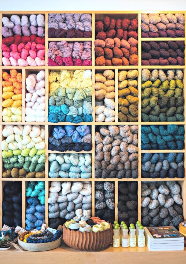 Wall of yarn balls in every colour. 