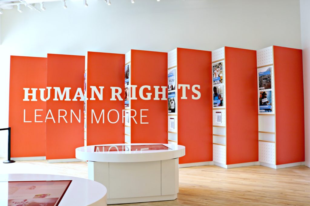 A sign reads: Human Rights, Learn More.