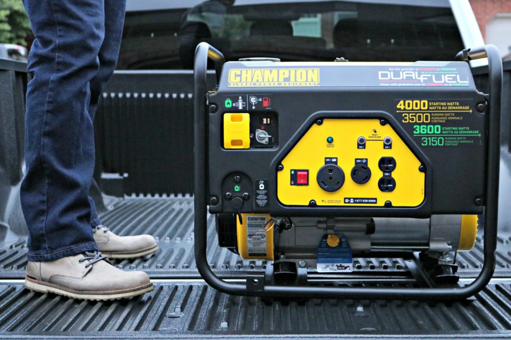 Champion generator being placed into a truck bed.