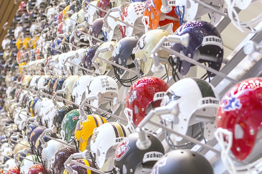 College football helmets are shown close up.