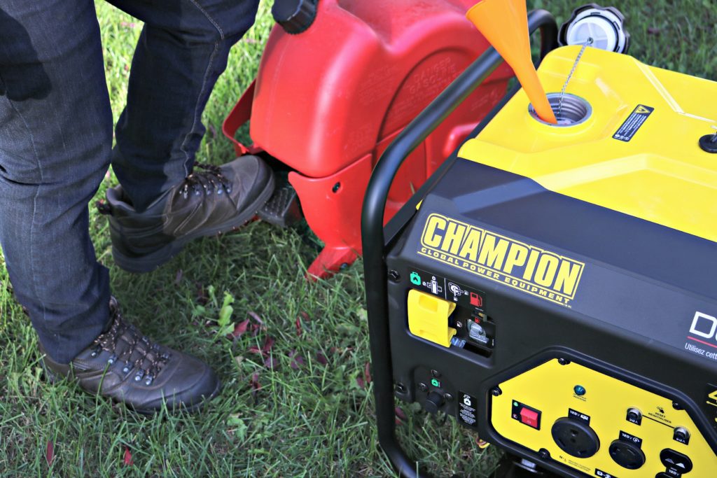 A man puts gas in his Champion generator. 