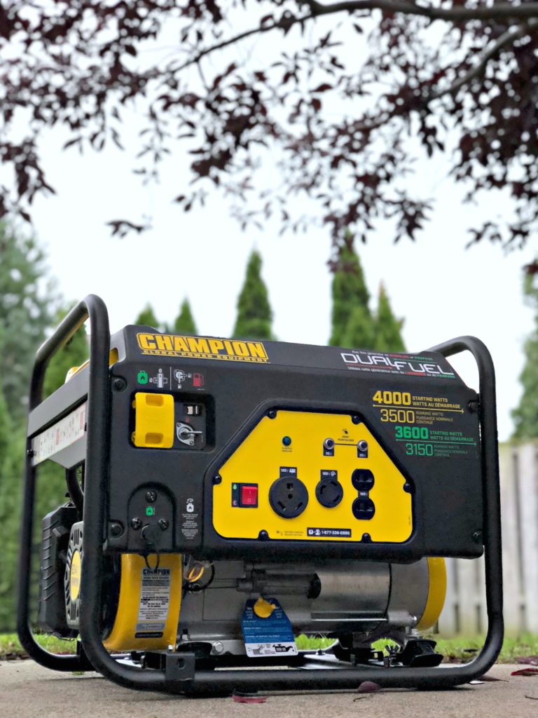 A Champion generator stands tall in a back yard.