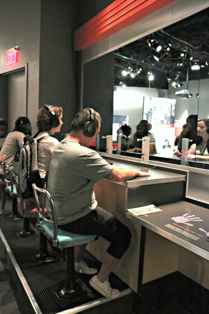 People sit at a mock diner booth and see how long they can last with violence and hatred being spewed at them through headphones.