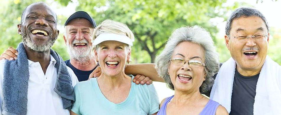 A group of multi-cultural seniors smile.