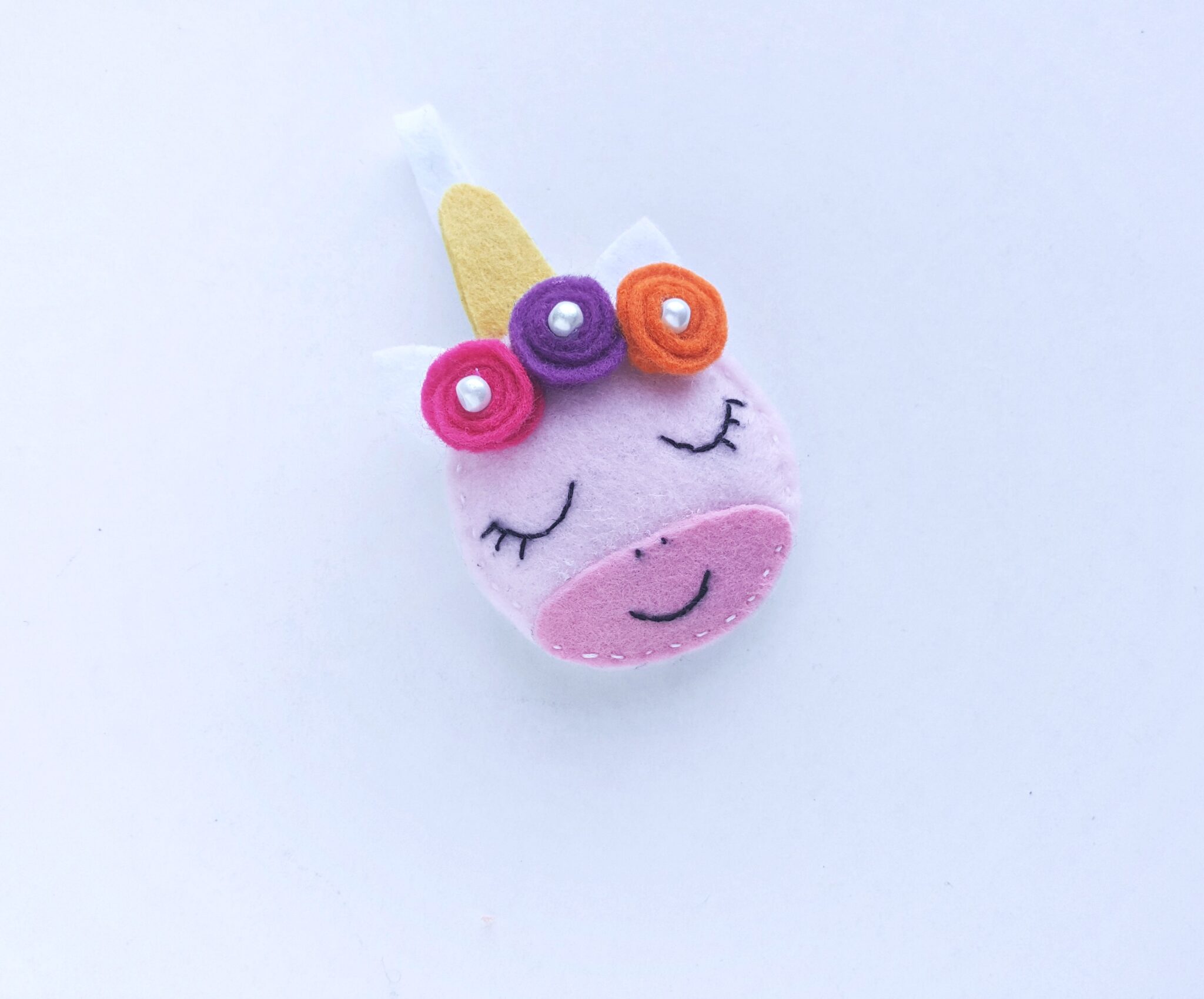 Little pearls were added to the floral crown on top of the felt unicorn's head.