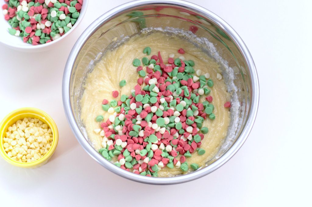 Red, green, and white chocolate chips are added into Christmas Blondies batter. 