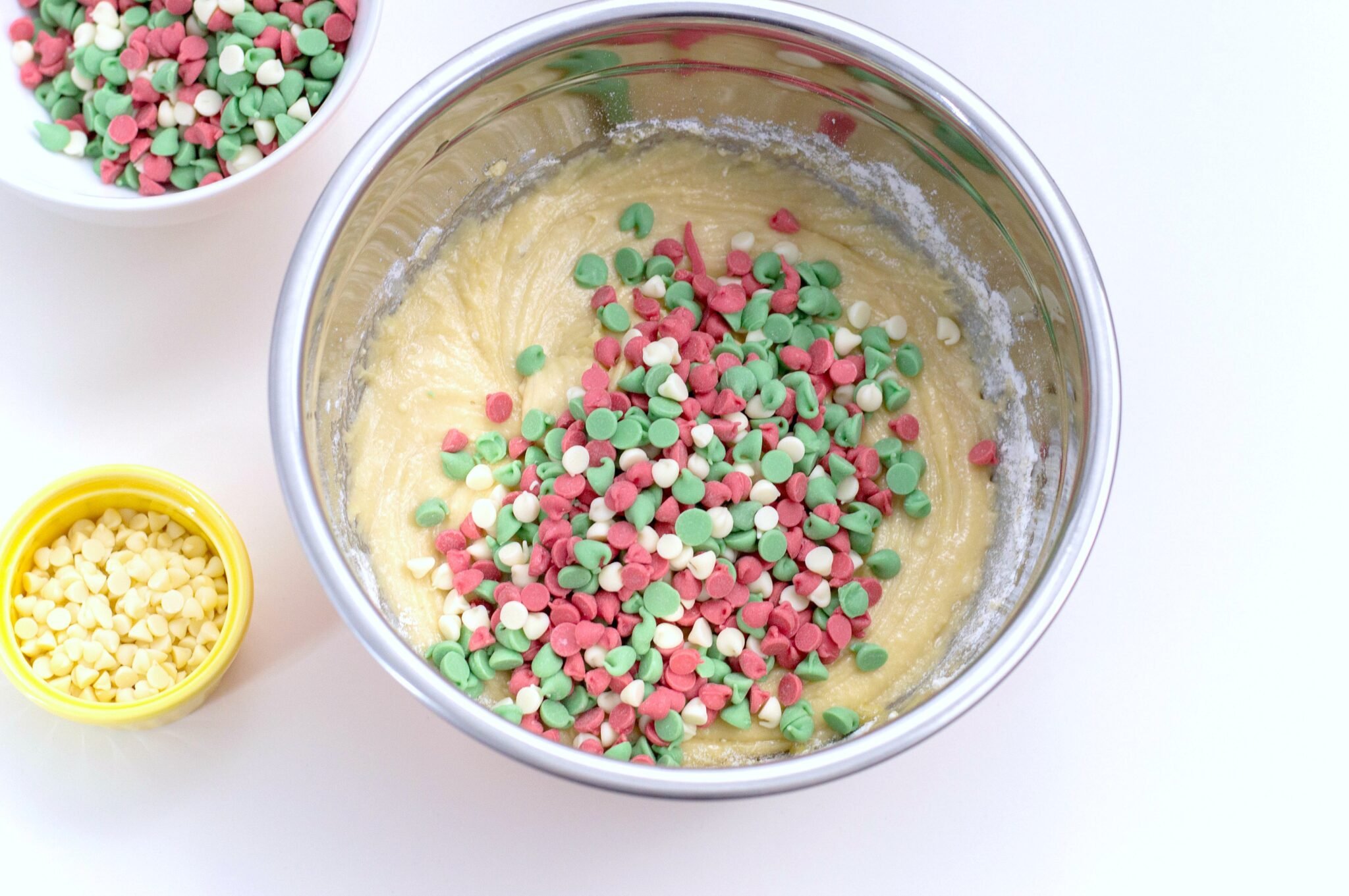 The holidays abound in desserts. In fact, it's one of my favourite parts about Christmas. Try making these. They are the Best Christmas Blondies recipe! #christmasdesserts #christmasblondies #blondies Red, green, and white chocolate chips are added into Christmas Blondies batter.