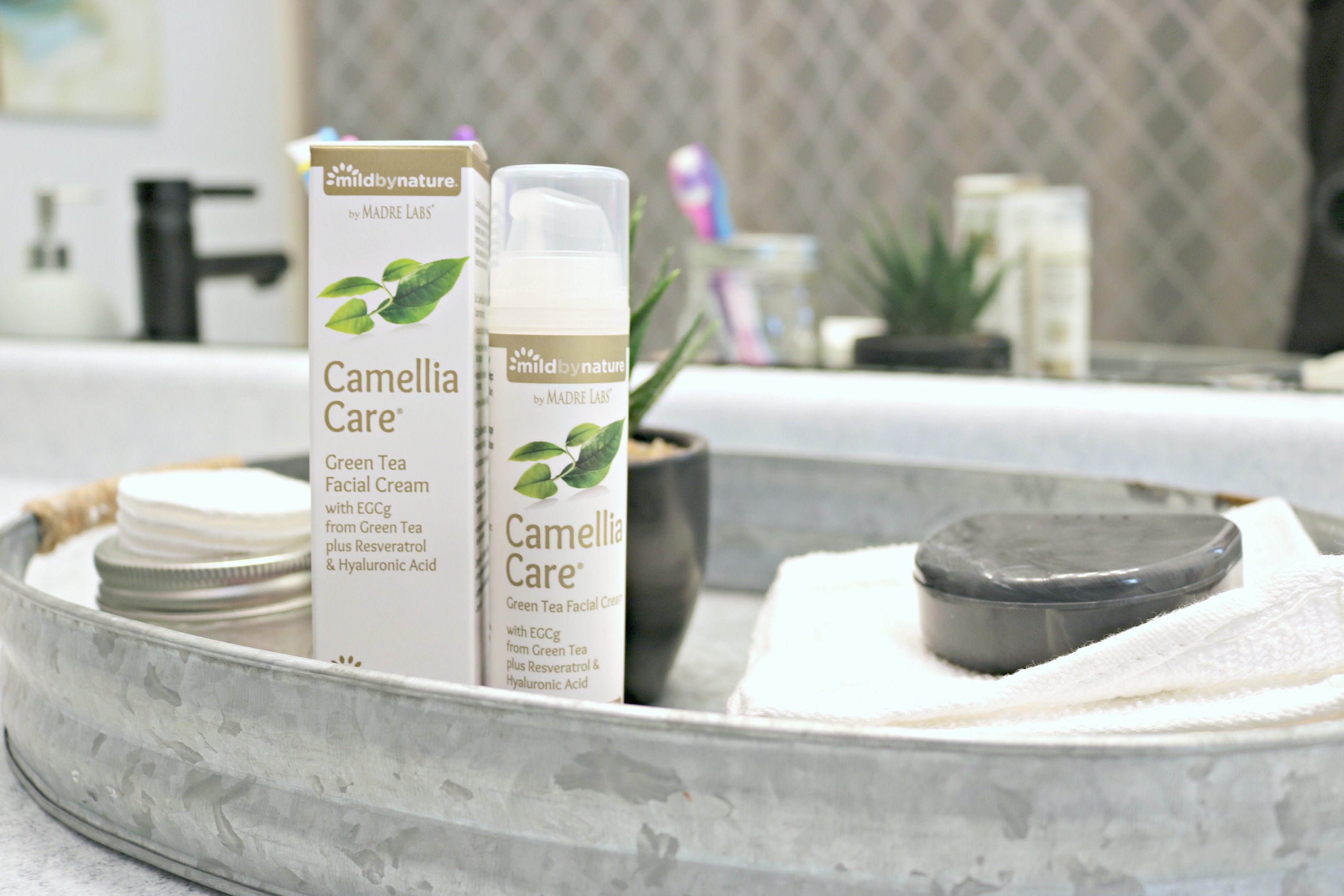 Camellia Care Green Tea Facial Cream in a washroom along with other necessities. 