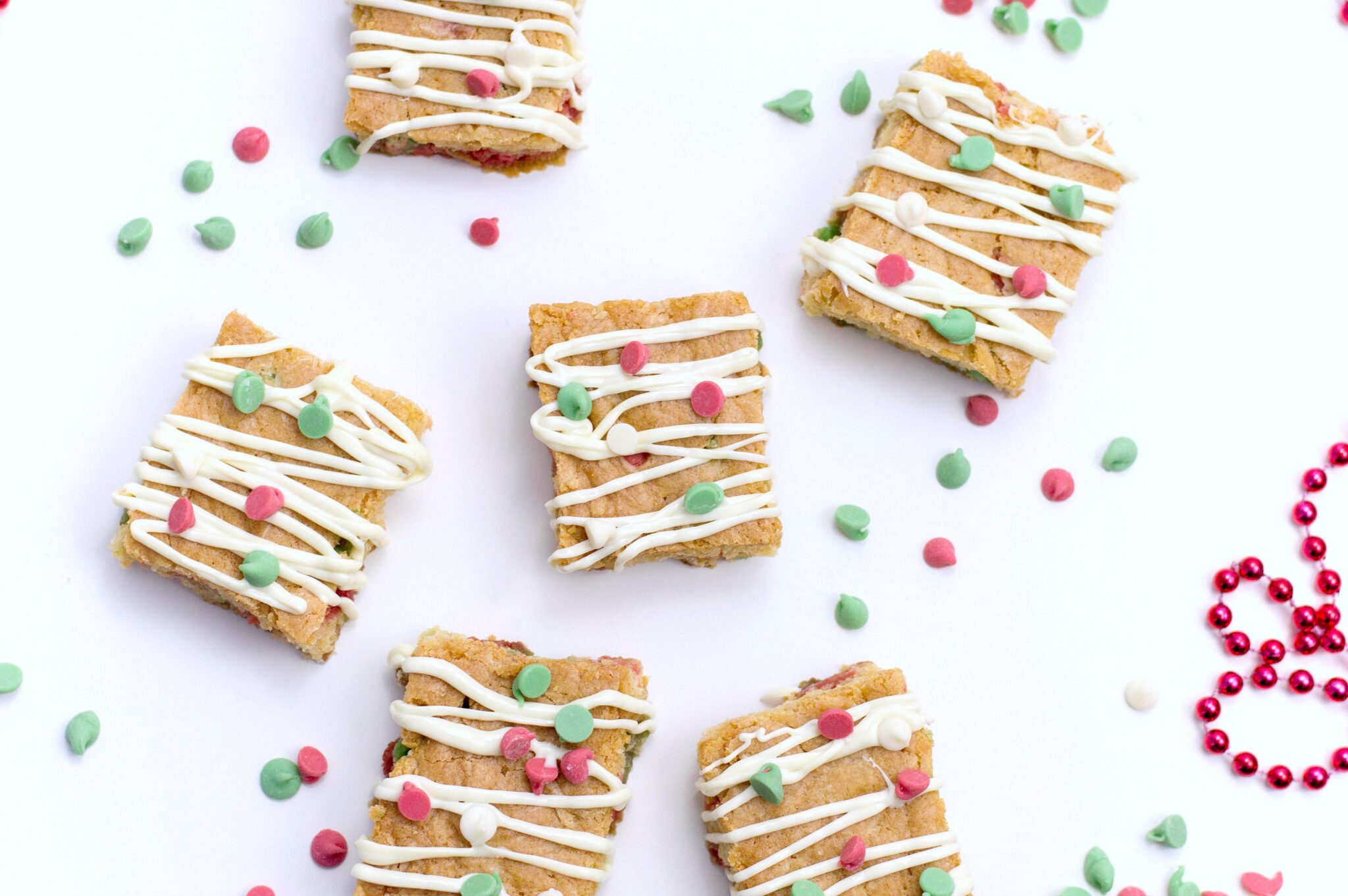 The holidays abound in desserts. In fact, it's one of my favourite parts about Christmas. Try making these. They are the Best Christmas Blondies recipe! #christmasdesserts #christmasblondies #blondies Top view of the finished product of Christmas Blondies.