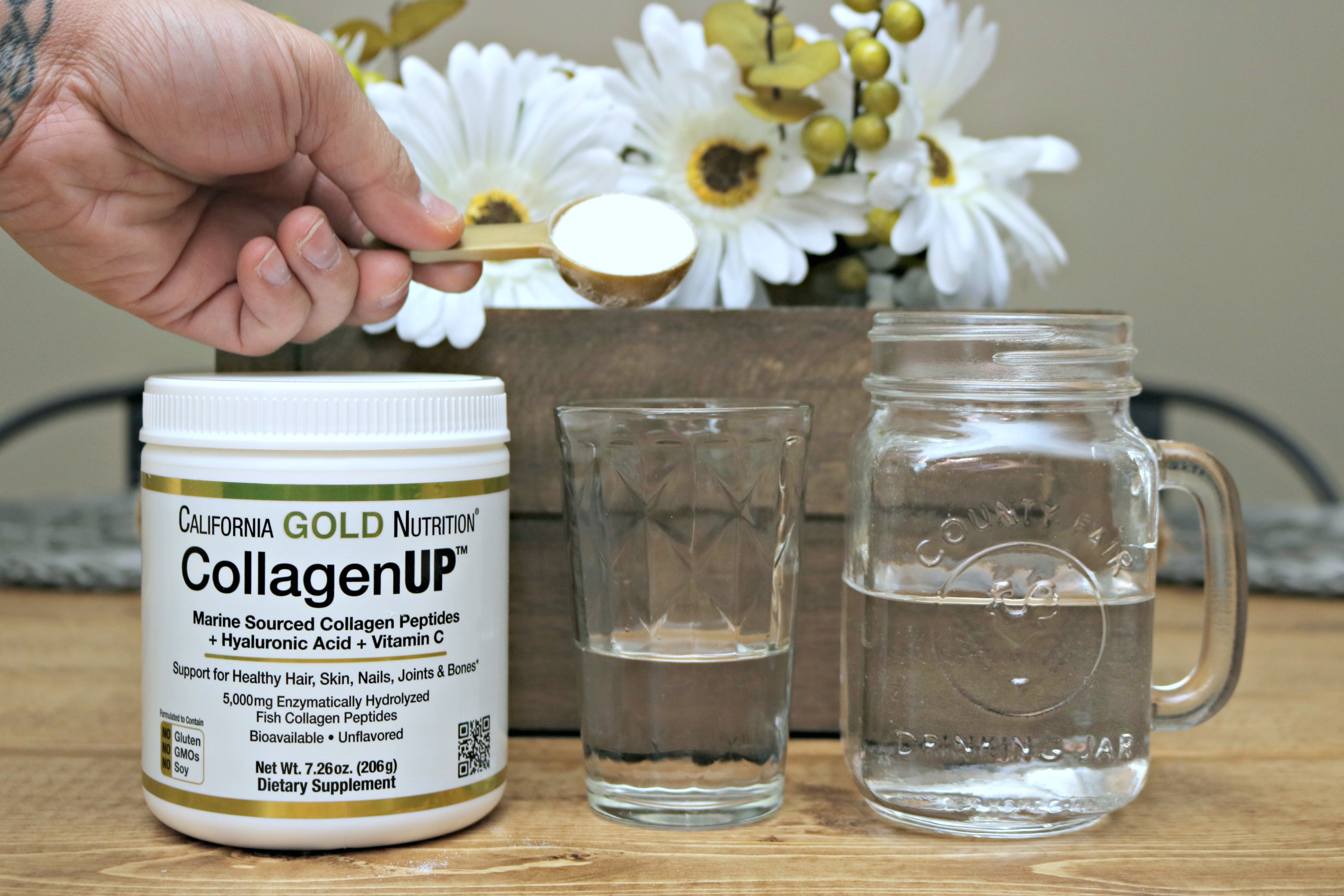 CollagenUP California Gold Nutrition being scooped into water.