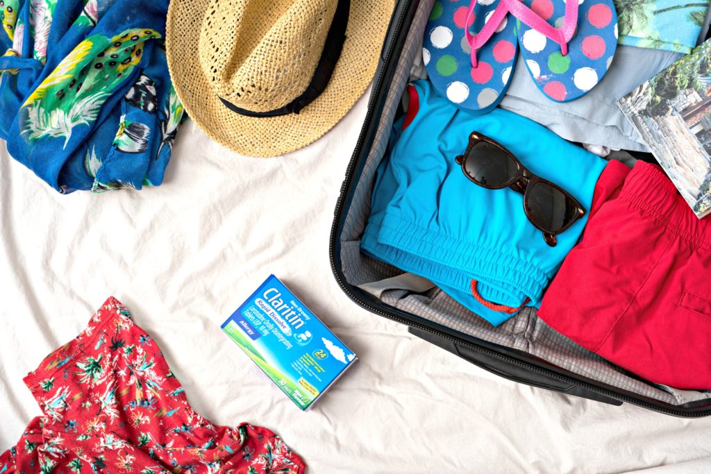 Suit case packed with essentials and Claritin. 