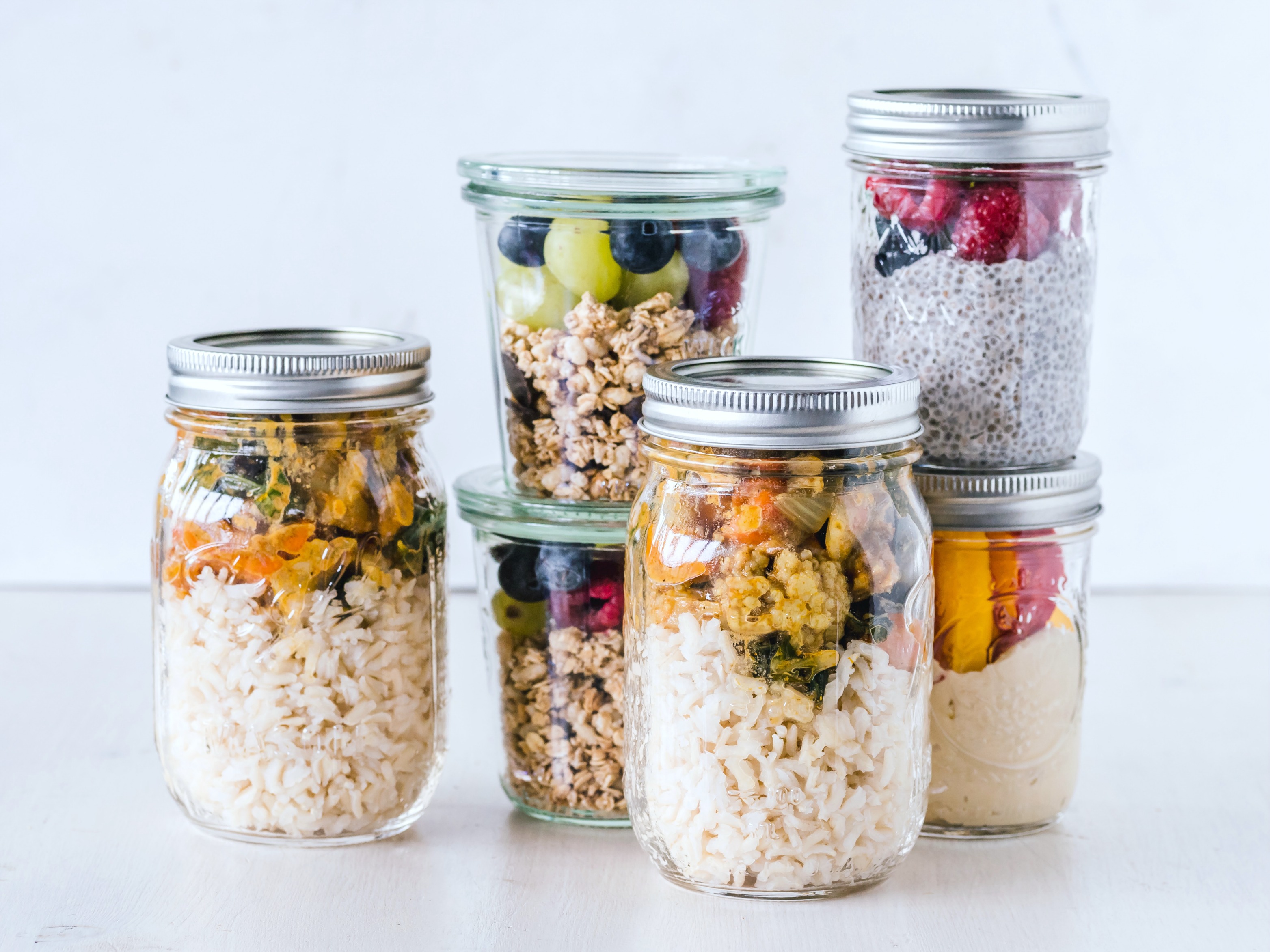 Mason jars filled with prepped food and snacks. 