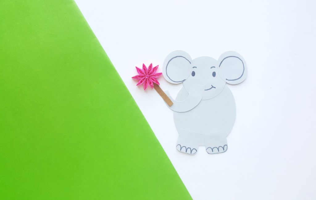 Horton now has a face, ears and is holding the pink flower. He's against a green and white background that looks like he's climbing a hill. 