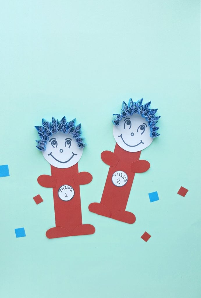 Thing 1 and Thing 2 paper craft are against a teal back drop.