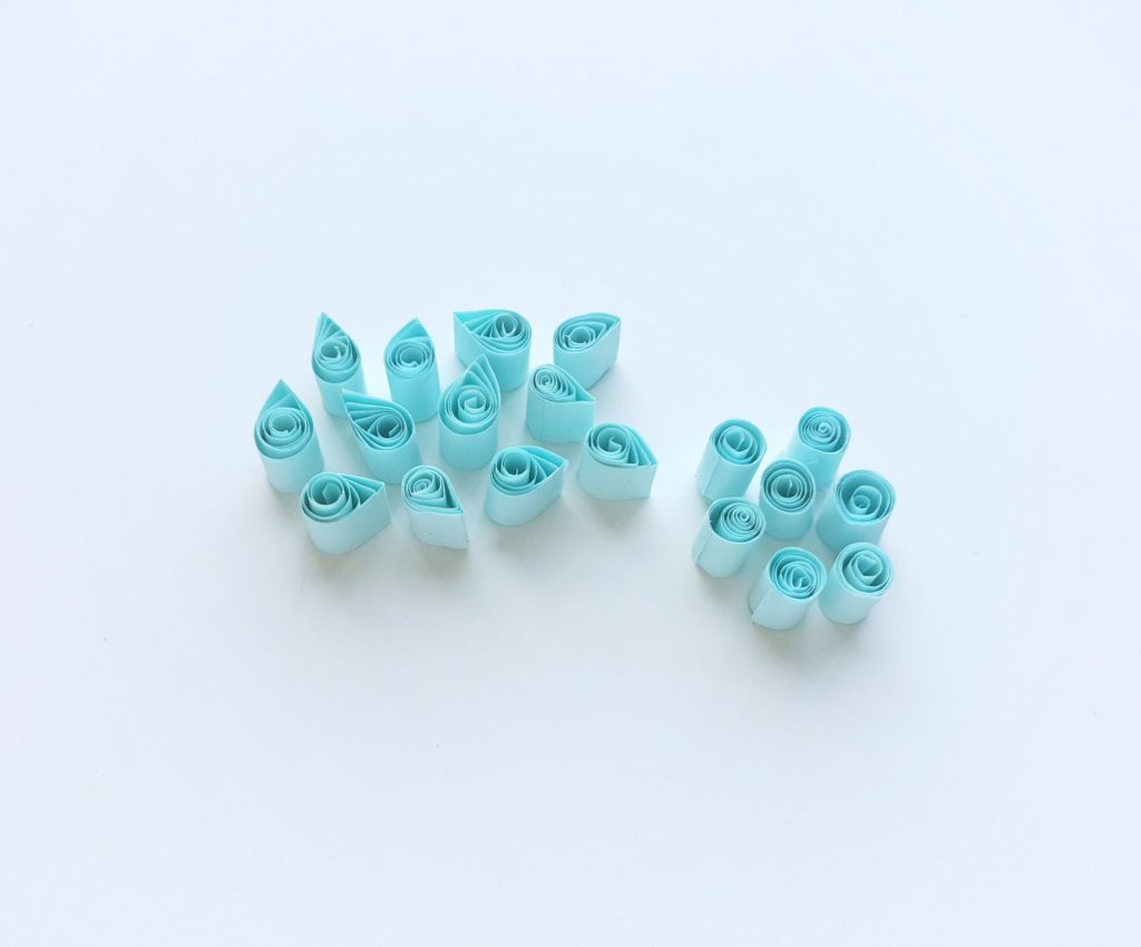 Blue tear drop quilled and cylinders that are quilled as well. 