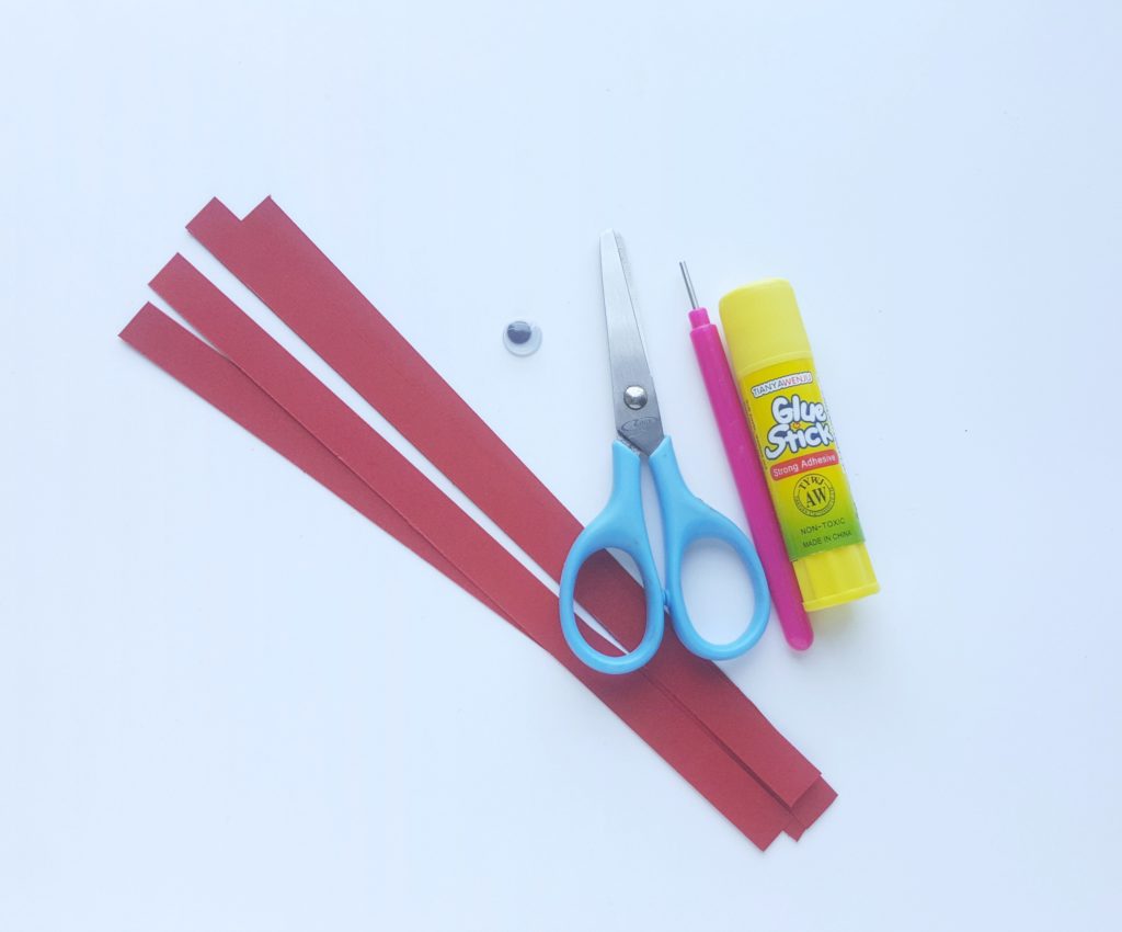 Supplies: Red quilling paper, one googly eye, scissors, glue stick, and quilling tool. 