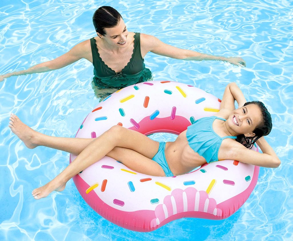 Mom floats with child on a donut pool float.