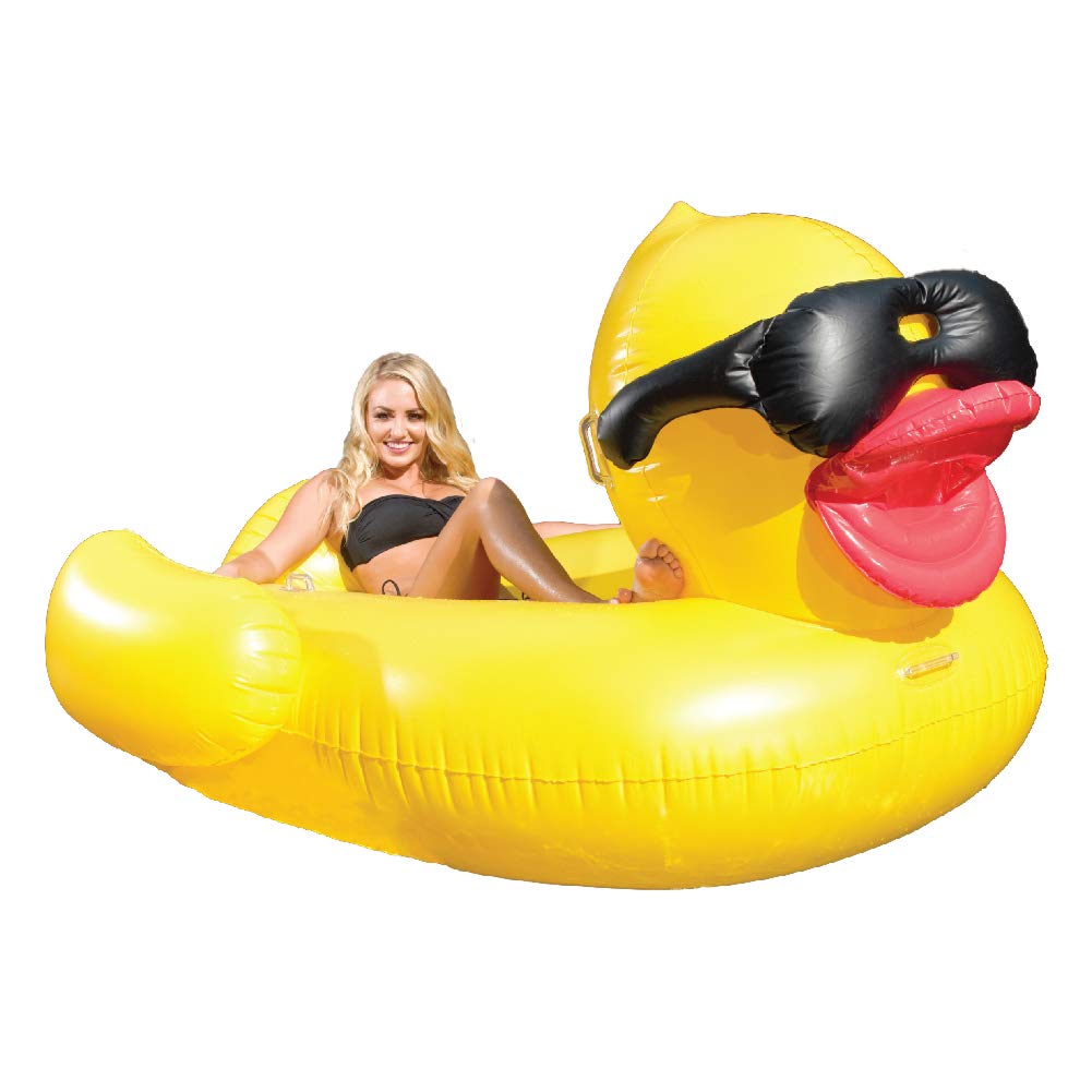 A woman sits in a huge rubber ducky pool float.