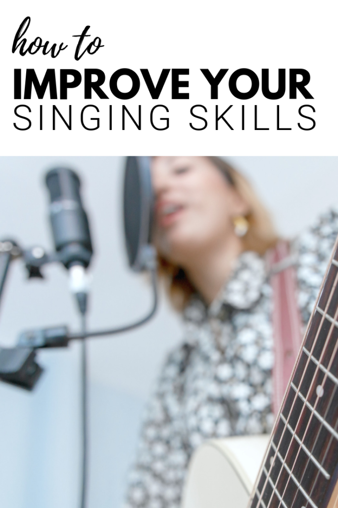 Woman sings into microphone with a guitar a banner above her says 'how to improve your singing skills.'