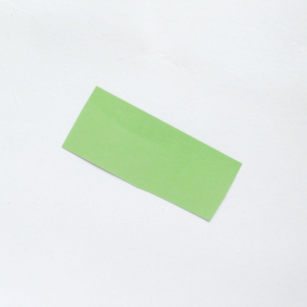 A green rectangle cut out of construction paper.