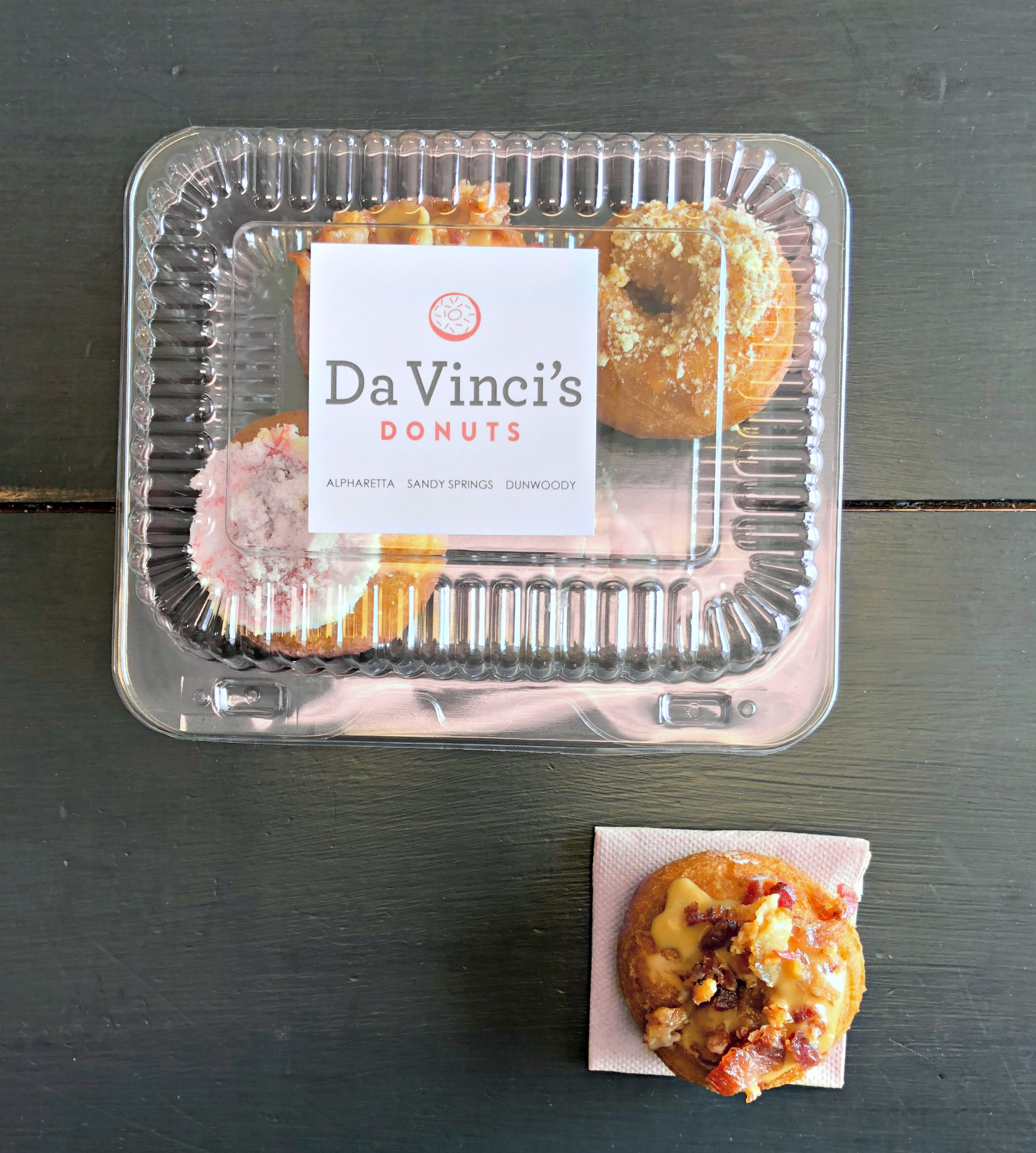 DaVinci's Donuts from Alpharetta. A clear package is shown and one is outside the box. 