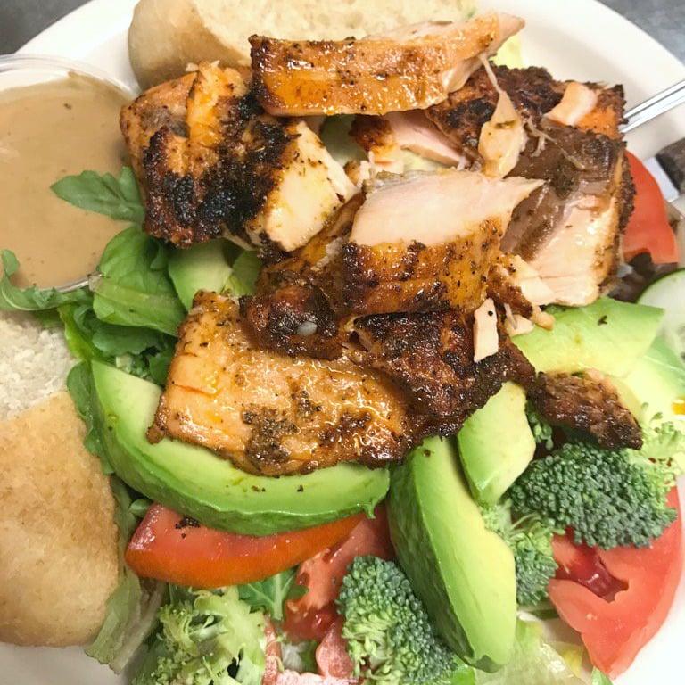 Blackened fish with veggies and bread. 