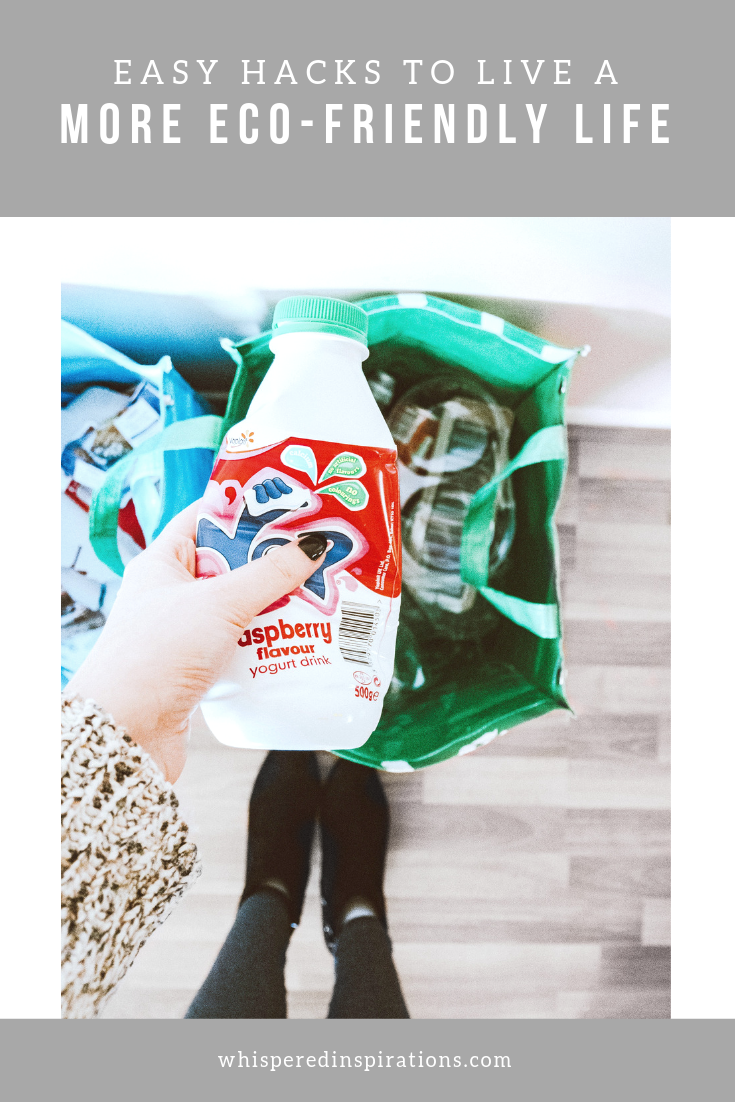 A banner reads, 'Easy Hacks to Live a More Eco-Friendly' and underneath is a picture of woman looking down at two bags and recycling, her feet are shown. 