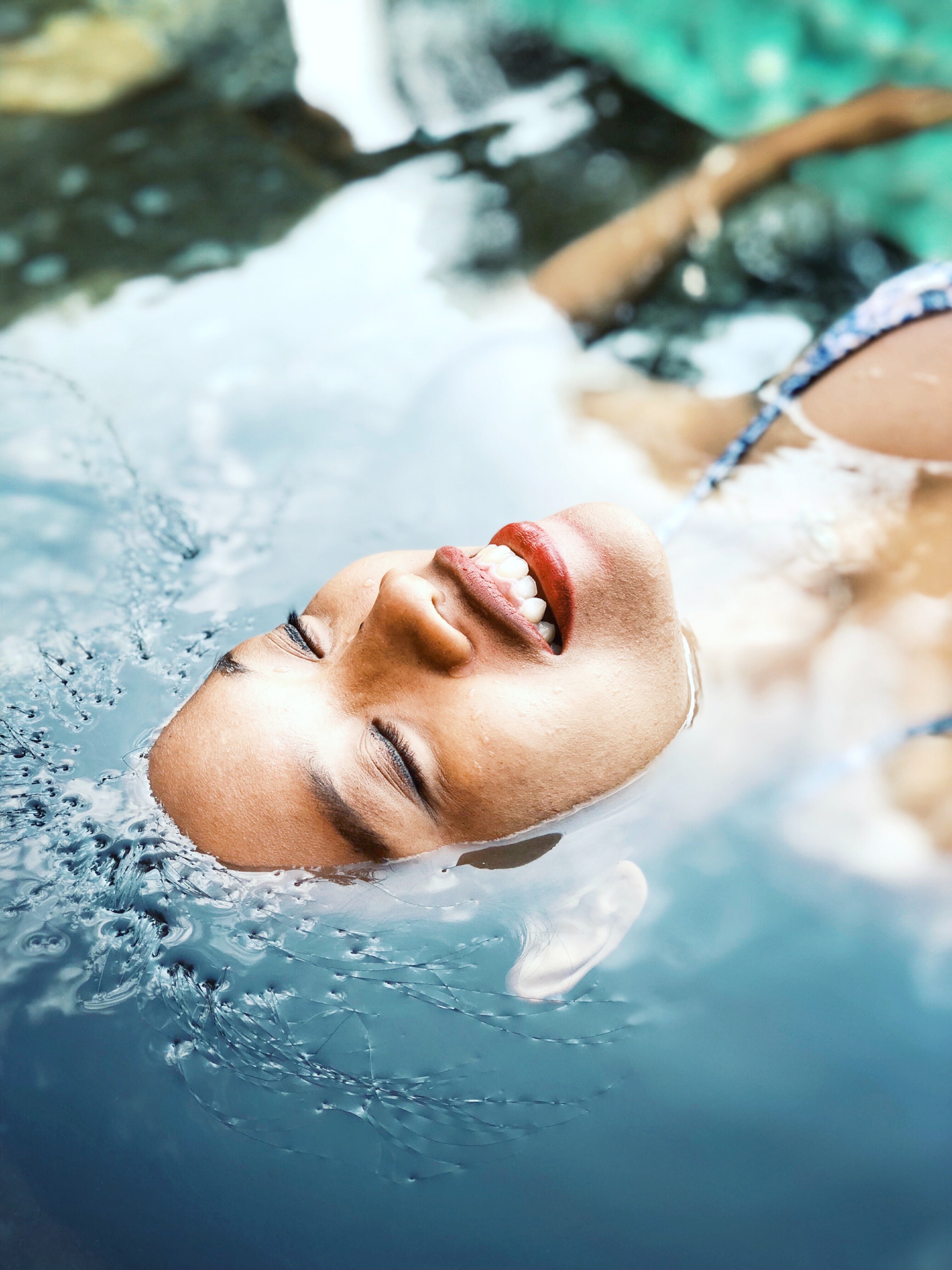 A woman floats in a pool at a spa. 